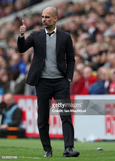 Josep Guardiola, Manager of Manchester City gives his team a thumbs up during The Emirates FA Cup Quarter-Final match between Middlesbrough and...