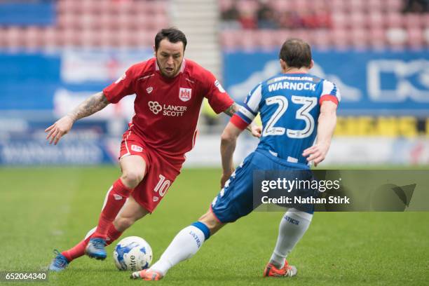 Lee Tomlin of Bristol City and Stephen Warnock of Wigan Athletic in action during the Sky Bet Championship match between Wigan Athletic and Bristol...