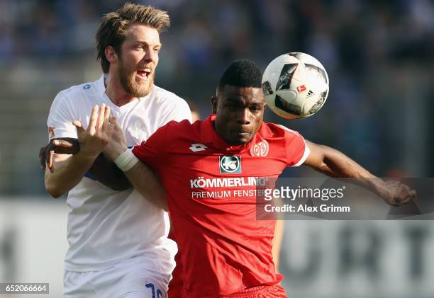 Peter Niemeyer of Darmstadt is challenged by Jhon Cordoba of Mainz during the Bundesliga match between SV Darmstadt 98 and 1. FSV Mainz 05 at...