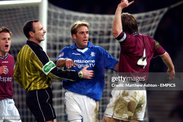 Referee Michael McCurry holds back Fernando Ricksen from Heart Of Midlothian's Steven Pressley