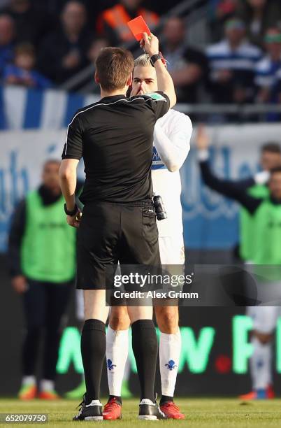 Referee Frank Willenborg shows the red card to Mario Vrancic of Darmstadt during the Bundesliga match between SV Darmstadt 98 and 1. FSV Mainz 05 at...