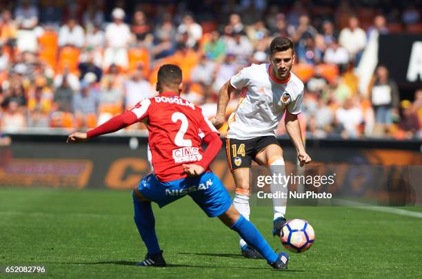 Jose Luis Gaya of Valencia CF and Douglas Pereira Dos Santos of Real Sporting de Gijon during their La Liga match between Valencia CF and Real...