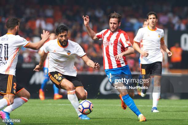 Ezequiel Garay of Valencia CF and Duje Cop of Real Sporting de Gijon during their La Liga match between Valencia CF and Real Sporting de Gijon at the...