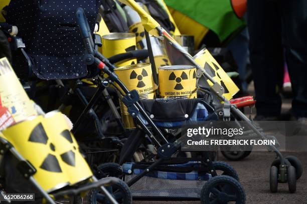 This picture taken on March 11 shows strollers pushed by anti nuclear activists as they take part in the commemoration of the nuclear disaster in...