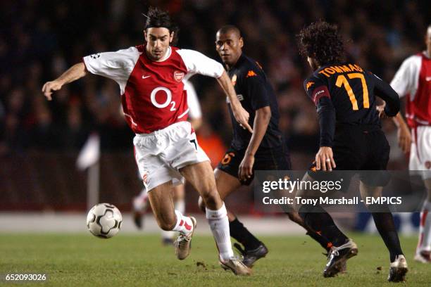 Arsenal's Robert Pires takes on Roma's Aldair and Damiano Tommasi