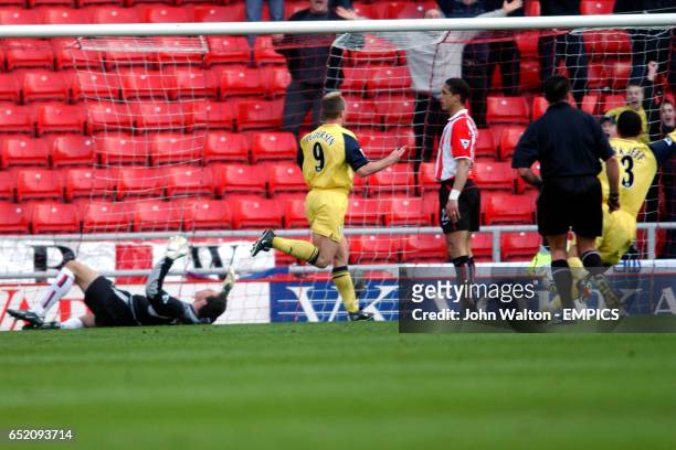 Bolton Wanderers' Henrik Pedesen starts to celebrate scoring the second goal as Sunderland's goalkeeper Thomas Sorensen is dejected