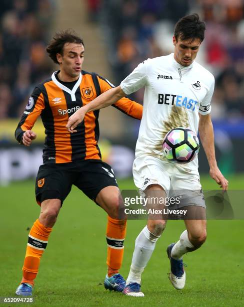 Lazar Markovic of Hull City watches Jack Cork of Swansea City during the Premier League match between Hull City and Swansea City at KCOM Stadium on...