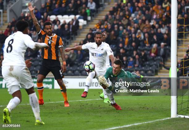 Eldin Jakupovic of Hull City saves from Wayne Routledge of Swansea City during the Premier League match between Hull City and Swansea City at KCOM...