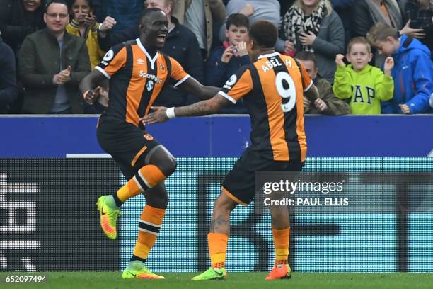 Hull City's Senegalese striker Oumar Niasse celebrates with Hull City's Uruguayan striker Abel Hernandez after scoring the opening goal of the...