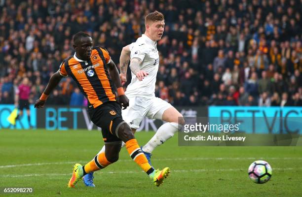 Oumar Niasse of Hull City scores their first goal during the Premier League match between Hull City and Swansea City at KCOM Stadium on March 11,...