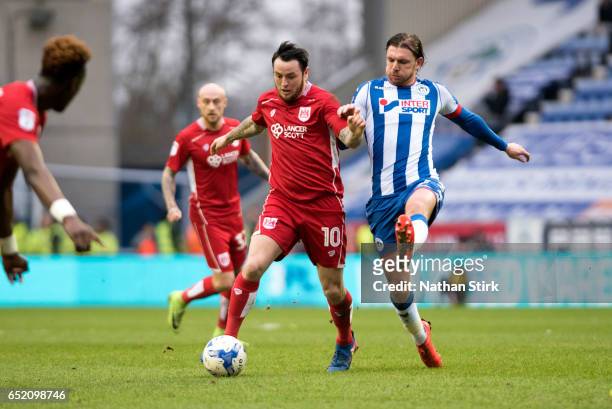 Lee Tomlin of Bristol City and Alex Gilbey of Wigan Athletic in action during the Sky Bet Championship match between Wigan Athletic and Bristol City...
