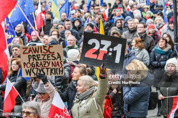 Protesters with banner that speaks 27:1 - the score of the EU Council president voting and European Union and Polish flags are seen on 11 March 2017...