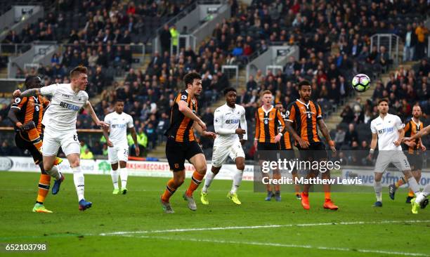 Alfie Mawson of Swansea City scores their first goal during the Premier League match between Hull City and Swansea City at KCOM Stadium on March 11,...