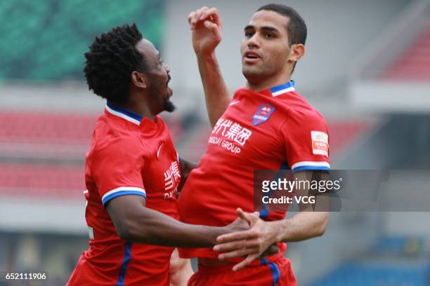 Alan Kardec of Chongqing Lifan celebrates with Fernandinho after scoring his team's first goal during the 2nd round match of CSL Chinese Football...