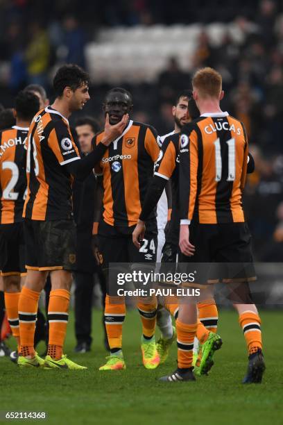 Hull City's Senegalese striker Oumar Niasse celebrates with teammates on the pitch after the English Premier League football match between Hull City...