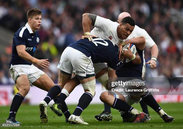 Nathan Hughes of England is tackled by Alex Dunbar of Scotland during the RBS Six Nations match between England and Scotland at Twickenham Stadium on...
