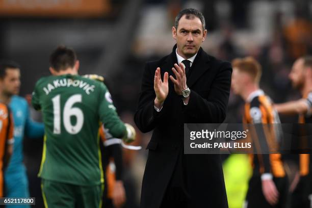 Swansea City's English head coach Paul Clement applauds supporters after the English Premier League football match between Hull City and Swansea City...