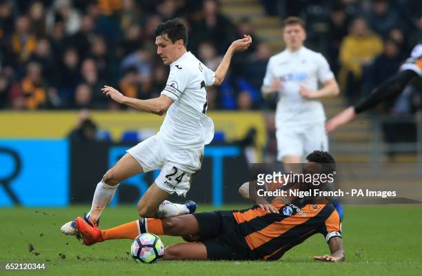 Swansea City's Jack Cork and Hull City's Tom Huddlestone battle for the ball during the Premier League match at the KCOM Stadium, Hull.
