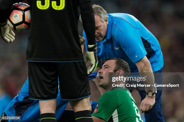 Lincoln City's Matt Rhead gets treatment after taking an elbow to the face during the Emirates FA Cup Quarter-Final match between Arsenal and Lincoln...