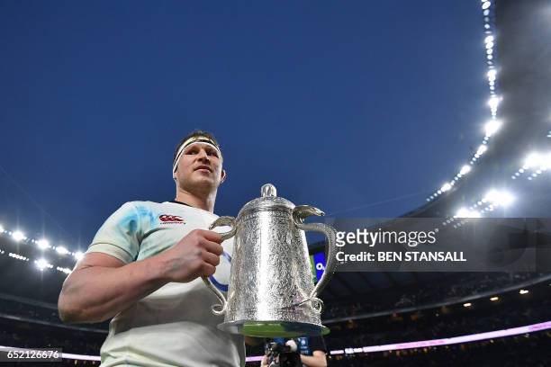 England's hooker and captain Dylan Hartley poses with the Calcutta Cup trophy atfter winning the Six Nations international rugby union match between...