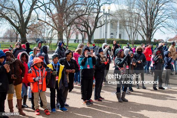 Demonstrators gather near The White House to protest President Donald Trump's travel ban on six Muslim countries on March 11, 2017 in Washington, DC....