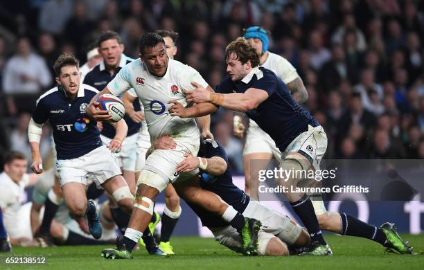 Mako Vunipola of England is tackled by Richie Gray of Scotland during the RBS Six Nations match between England and Scotland at Twickenham Stadium on...