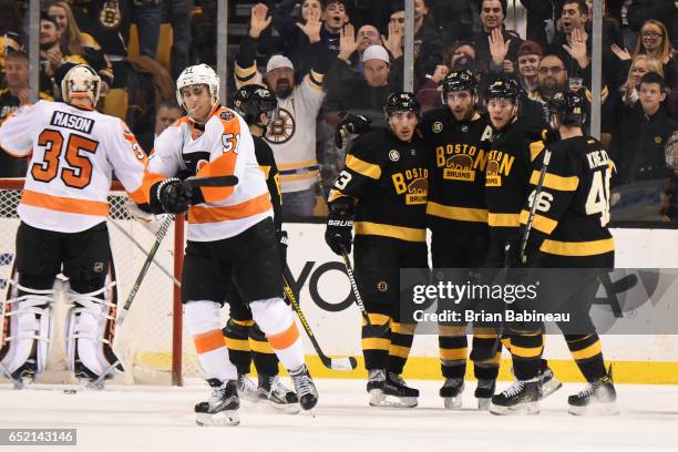 Brad Marchand, Patrice Bergeron, David Pastrnak and David Krejci of the Boston Bruins celebrate a goal against the Philadelphia Flyers at the TD...