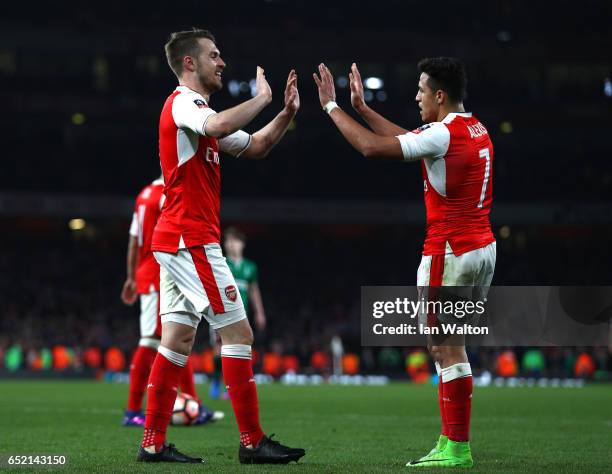 Aaron Ramsey of Arsenal celebrates scoring his sides fifth goal with Alexis Sanchez of Arsenal during The Emirates FA Cup Quarter-Final match between...