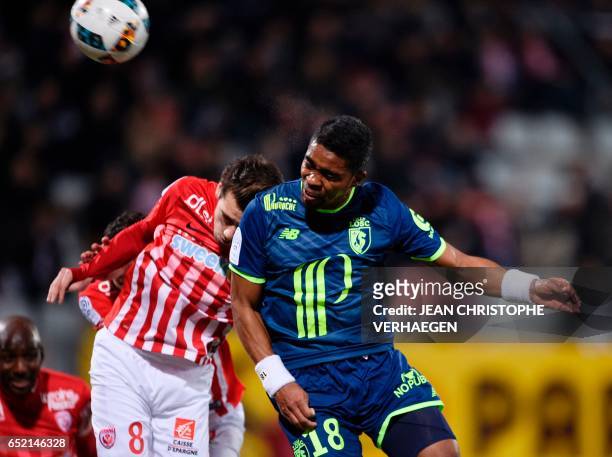 Nancy's French midfielder Vincent Marchetti vies with Lille's French defender Franck Beria during the French L1 football match between Nancy and...