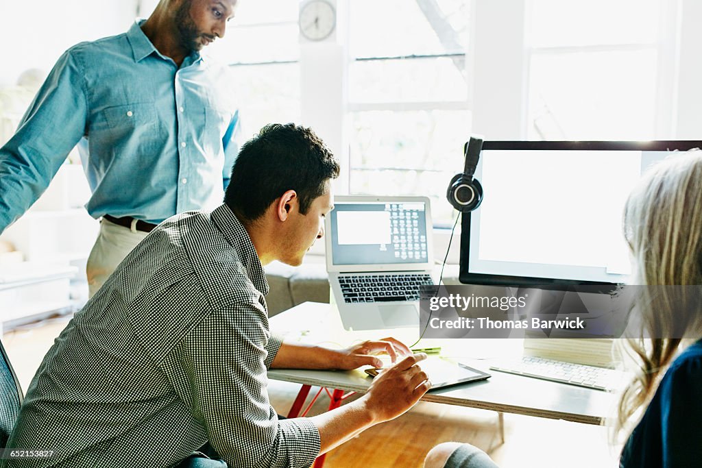 Businessman referencing data on digital tablet