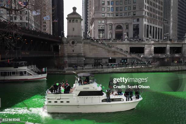 Boaters navigate the Chicago River shortly after it was dyed green in celebration of St. Patrick's Day on March 11, 2017 in Chicago, Illinois. Dyeing...