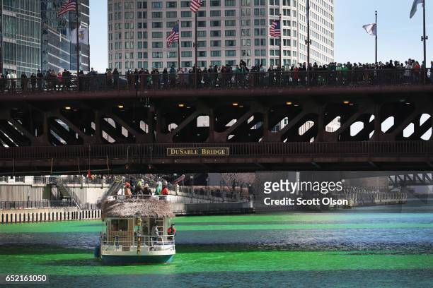 Boaters navigate the Chicago River shortly after it was dyed green in celebration of St. Patrick's Day on March 11, 2017 in Chicago, Illinois. Dyeing...