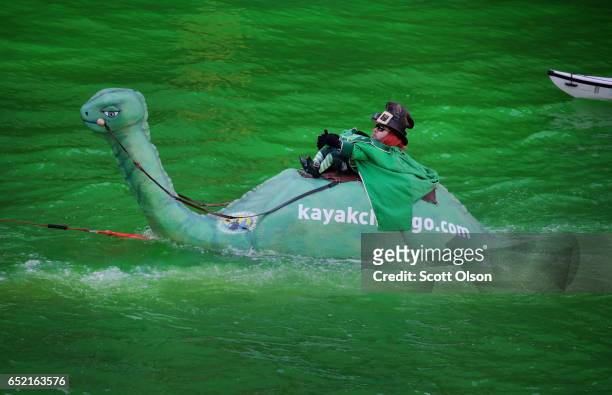 Watercraft navigates the Chicago River shortly after it was dyed green in celebration of St. Patrick's Day on March 11, 2017 in Chicago, Illinois....