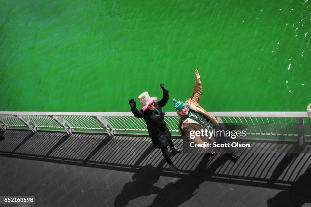 Visitors take selfies along the Chicago River shortly after it was dyed green in celebration of St. Patrick's Day on March 11, 2017 in Chicago,...