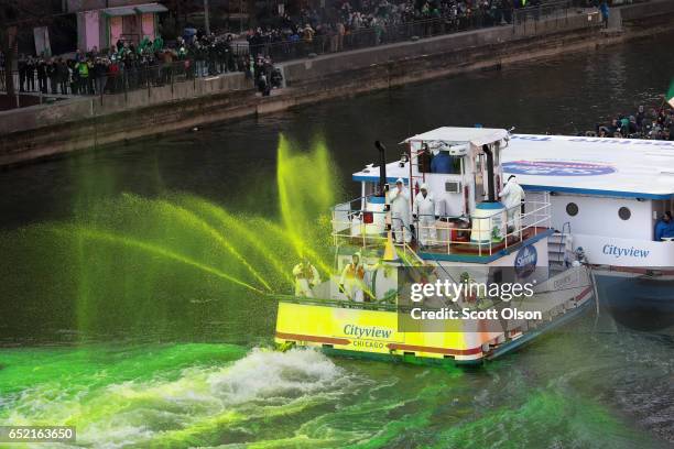 Workers dye the Chicago River green in celebration of St. Patrick's Day on March 11, 2017 in Chicago, Illinois. Dyeing the river has been a St....