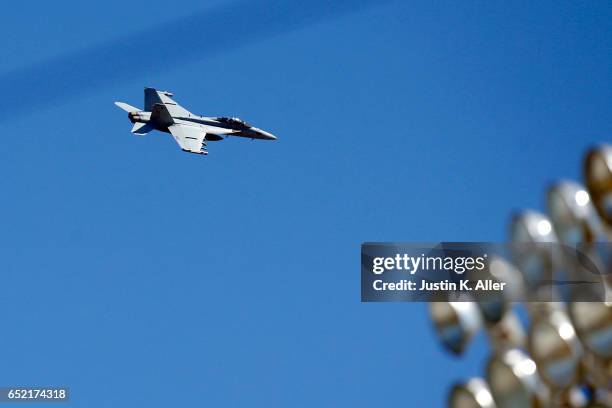 An F/A-18 Hornet flys over George M. Steinbrenner Field during a spring training game between the New York Yankees and the Detroit Tigers at George...