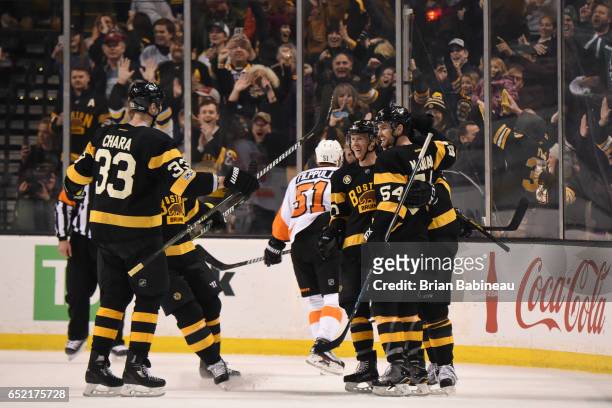 Zdeno Chara, Riley Nash and Adam McQuaid of the Boston Bruins celebrate a goal against the Philadelphia Flyers at the TD Garden on March 11, 2017 in...