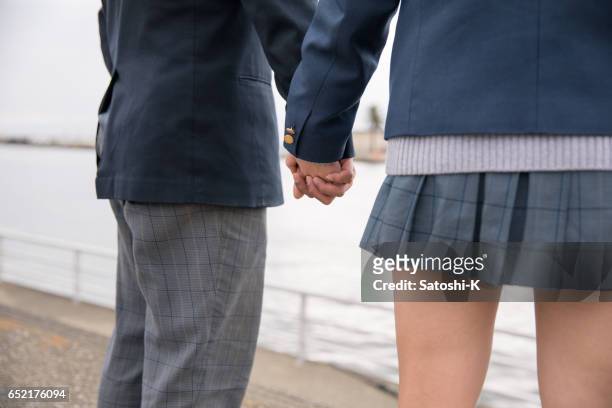 high school student couple shaking hands - eternal youth stock pictures, royalty-free photos & images