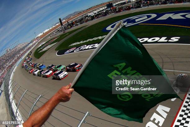 Kyle Busch, driver of the NOS Energy Drink Rowdy Toyota, and Brad Keselowski, driver of the Discount Tire Ford, lead the field to the green flag to...