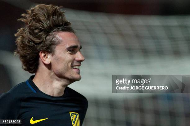 Atletico Madrid's French forward Antoine Griezmann celebrates after scoring during the Spanish league football match Granada CF vs Club Atletico de...