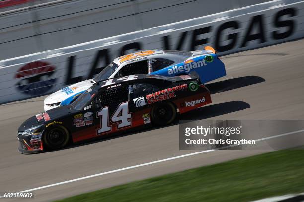 Yeley, driver of the Superior Essex Toyota, races Spencer Gallagher, driver of the Allegiant Chevrolet, during the NASCAR XFINITY Series Boyd Gaming...