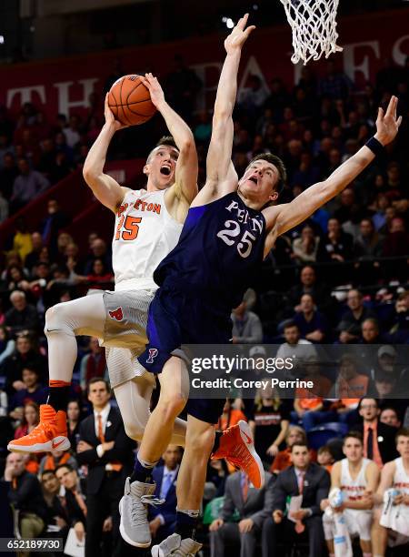 Steven Cook of the Princeton Tigers is fouled by AJ Brodeur of the Pennsylvania Quakers during the second half at The Palestra during a Ivy League...