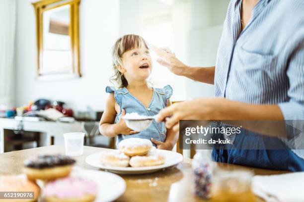 mother and daughter making sweet donuts in the kitchen - sugar glider stock pictures, royalty-free photos & images