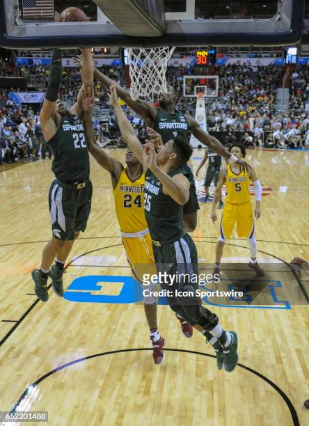 Michigan State Spartans guard Miles Bridges scores on a dunk against Minnesota Golden Gophers forward Eric Curry in the third round of the Big 10...