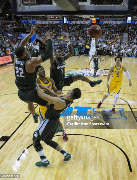 Michigan State Spartans guard Miles Bridges scores on a dunk against Minnesota Golden Gophers forward Eric Curry in the third round of the Big 10...