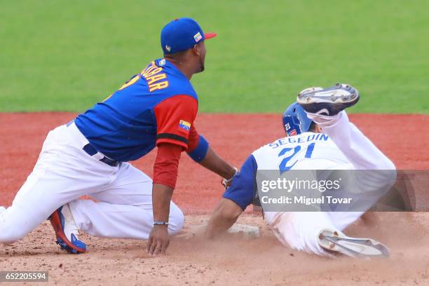 Alcides Escobar#2 of Venezuela tags out Rob Segedin of Italy in the bottom of the seventh inning during the World Baseball Classic Pool D Game 3...