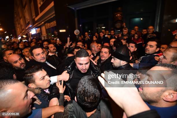 Turkish residents of the Netherlands gather for a protest outside Turkey's consulate in Rotterdam on March 11, 2017. Protests erupted in the Dutch...