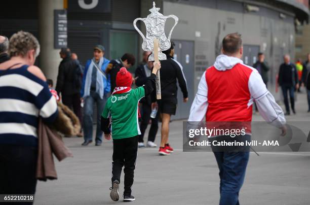 Fan carries a homemade foil FA Cup trophy ahead of The Emirates FA Cup Quarter-Final match between Arsenal and Lincoln City at Emirates Stadium on...