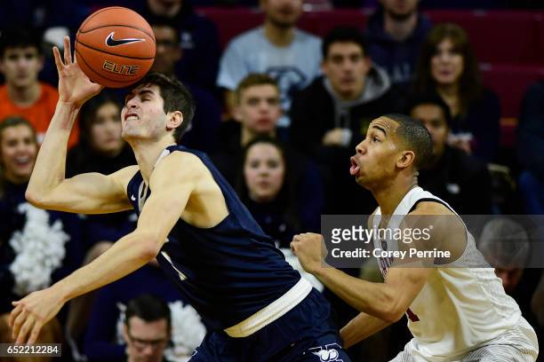 Anthony Dallier of the Yale Bulldogs bobbles the ball as Siyani Chambers of the Harvard Crimson looks on during the second half at The Palestra...
