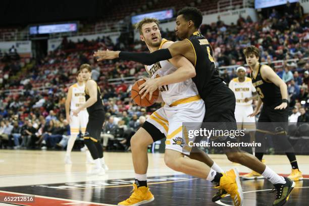 Northern Kentucky Norse forward Carson Williams looks to shoot over Milwaukee Panthers guard Jeremy Johnson during the Horizon League championship...